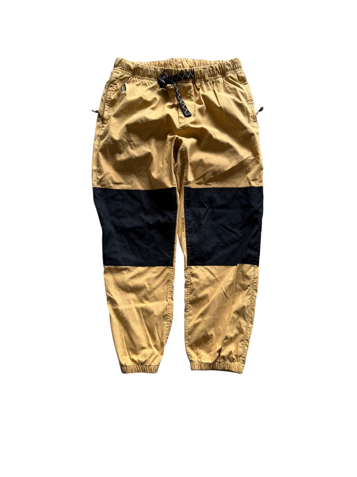 Aged Arc mustard yellow and black color-blocked joggers with an elastic waistband and drawstring closure