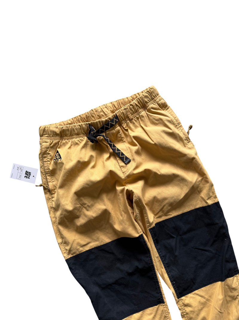 Aged Arc mustard yellow and black color-blocked outdoor trousers with an elasticated waist and patterned belt
