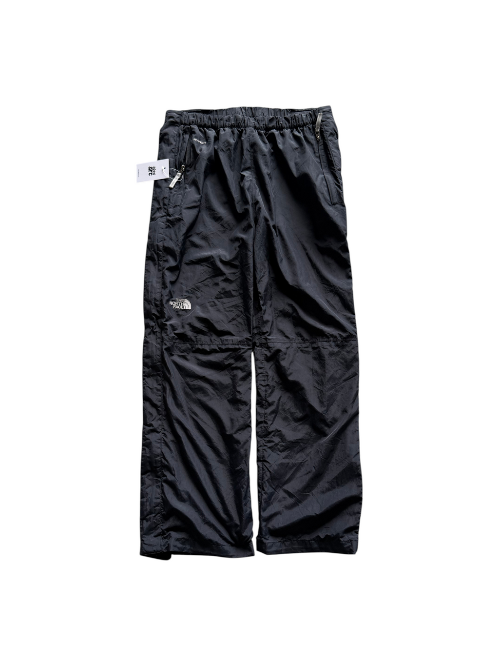 Aged Arc black The North Face HyVent waterproof rain pants with an elastic waistband and zippered pockets.