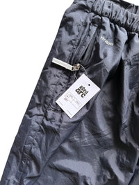 Aged Arc black nylon track pants featuring a zippered pocket and Hyvent branding detail.